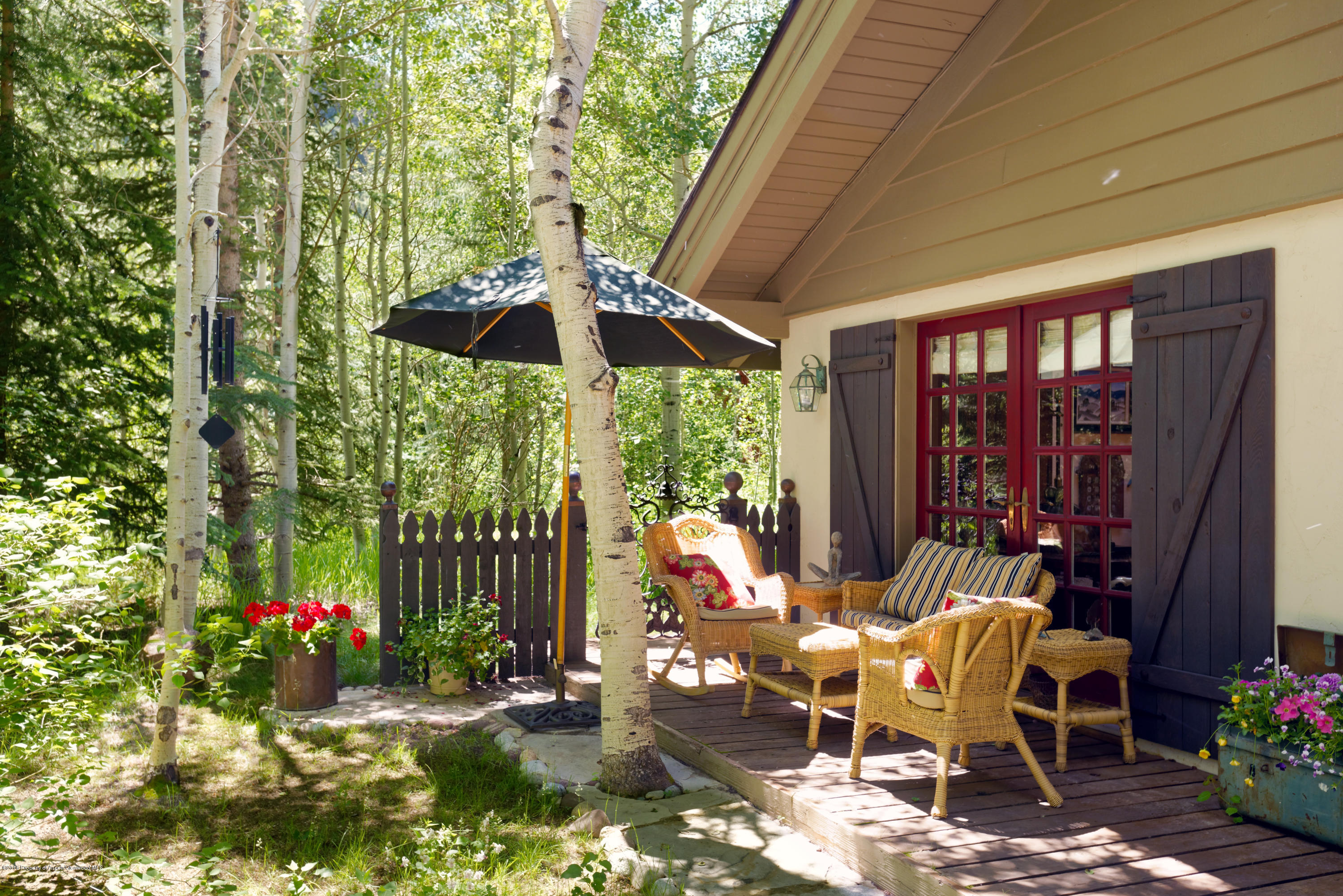 1300 Riverside Drive Aspen, CO 81611 - Photo 22 of 24 a view of a patio with a table and chairs under an umbrella