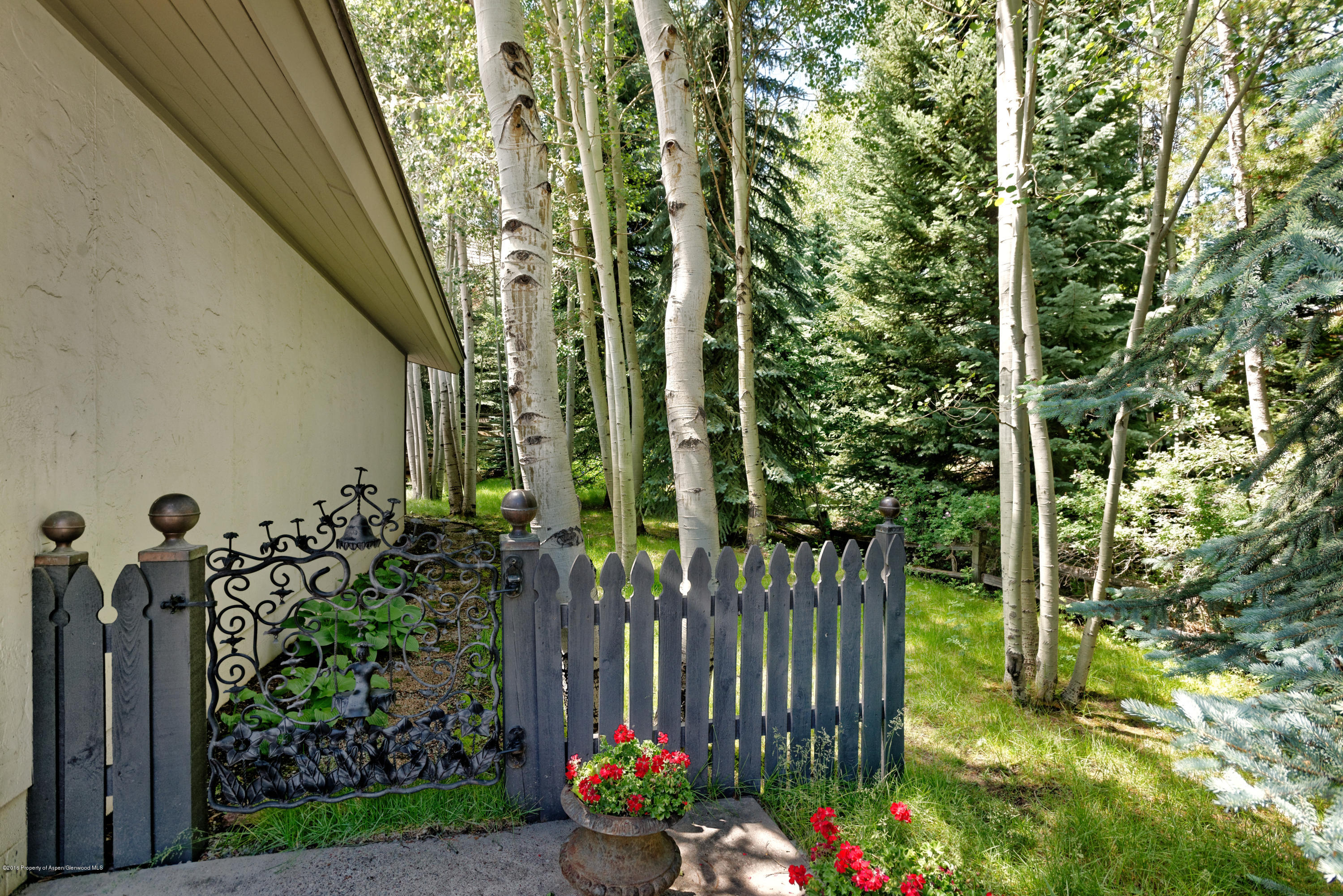 1300 Riverside Drive Aspen, CO 81611 - Photo 23 of 24 a view of a pathway of a house with a fountain back yard