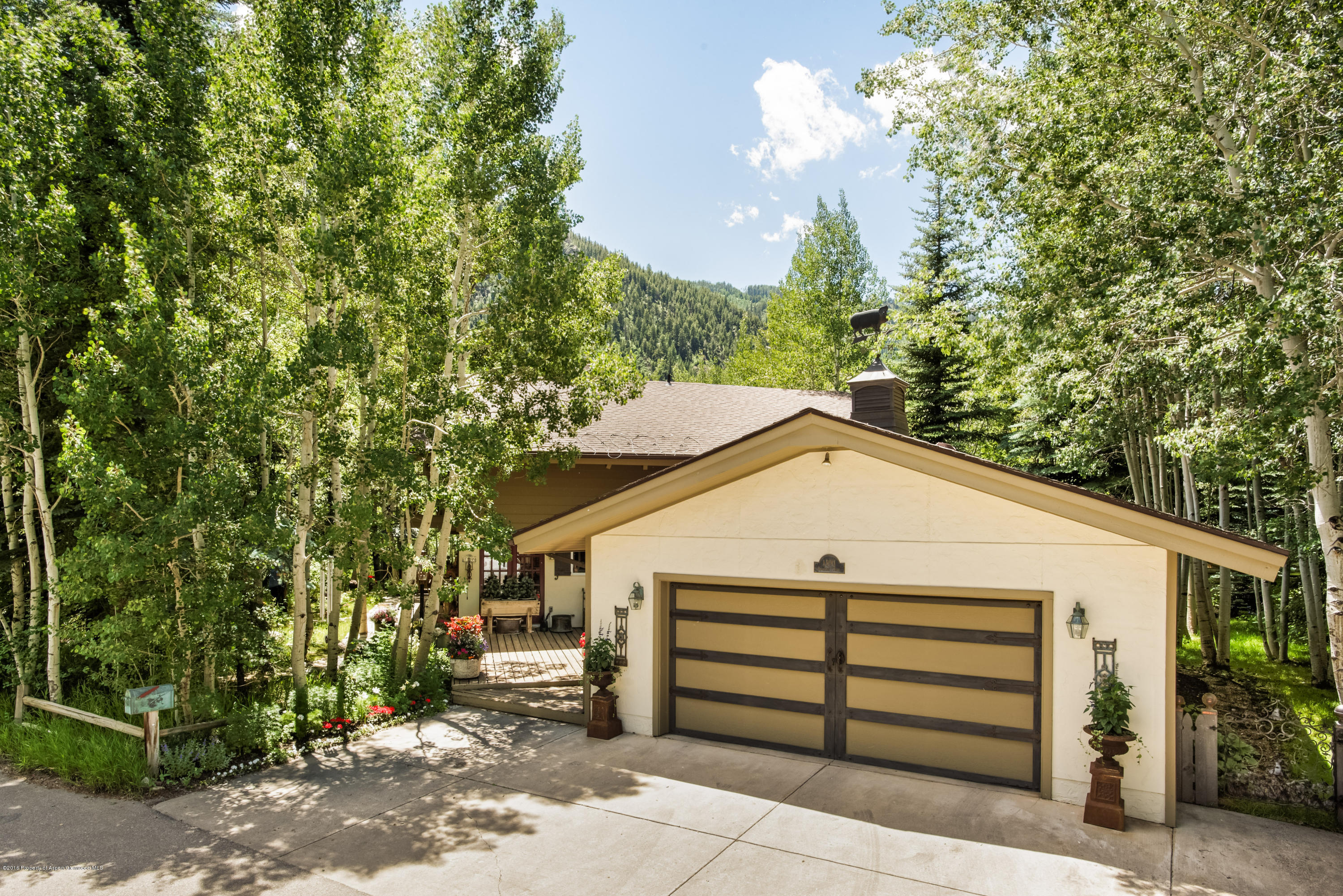1300 Riverside Drive Aspen, CO 81611 - Photo 24 of 24 a white house that has tree in front of it