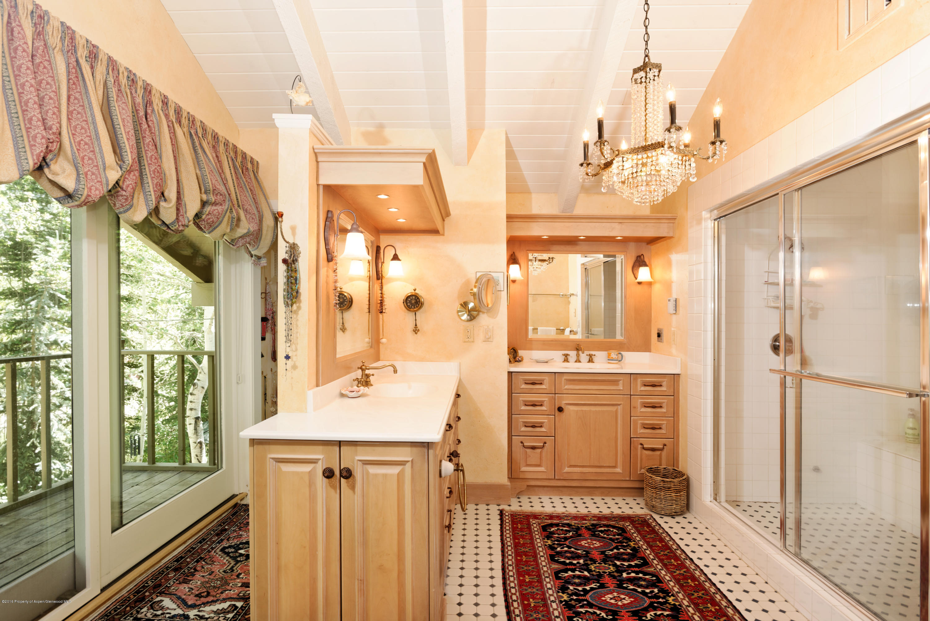 1300 Riverside Drive Aspen, CO 81611 - Photo 10 of 24 a bathroom with a double vanity sink a mirror and a shower