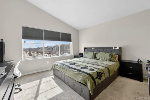 a bedroom with a large bed and a large window