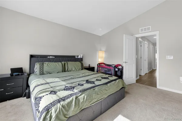 a bedroom with a bed and a lamp