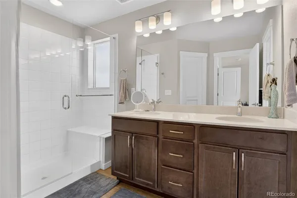 a bathroom with double sink and a mirror