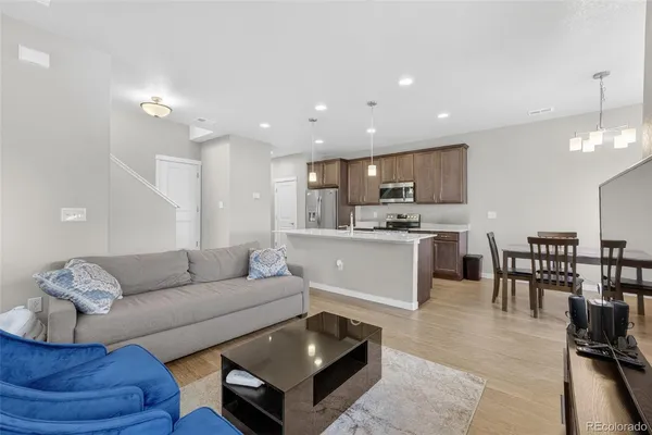 a living room kitchen with a couch and a dining table