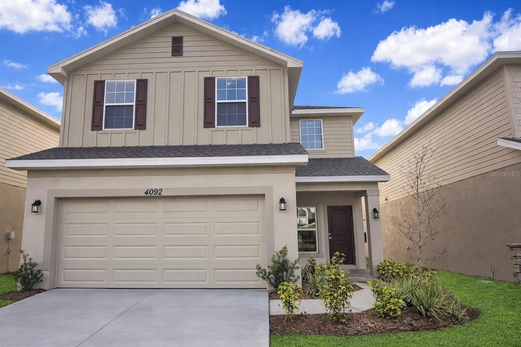 4092 Sagefield Drive Harmony, FL 34773 - Photo 1 of 16 a front view of a house with a yard and garage