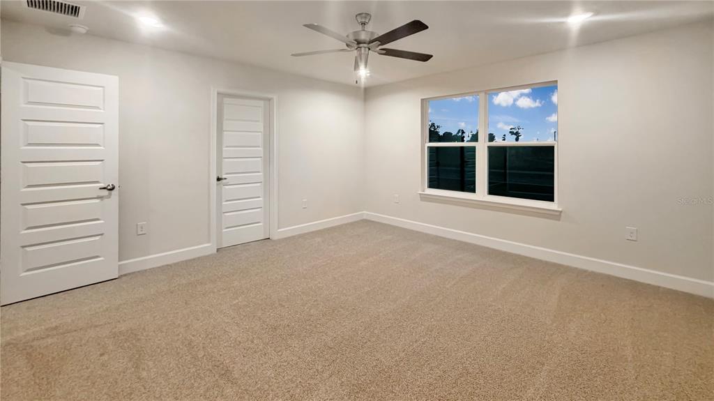 4092 Sagefield Drive Harmony, FL 34773 - Photo 11 of 16 en empty room with windows and ceiling fan