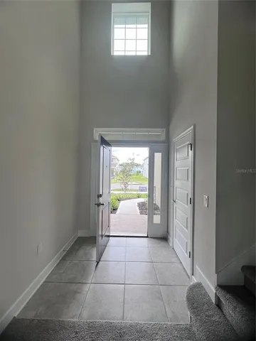a bathroom with a tub shower and window