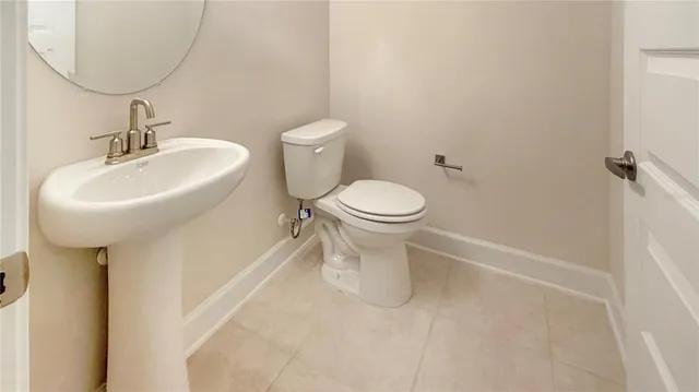a bathroom with a sink toilet and a mirror