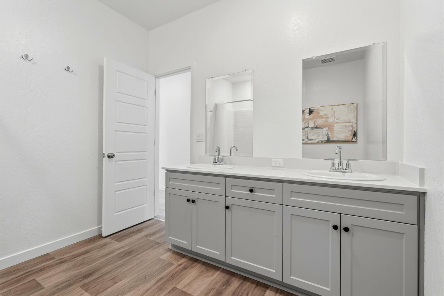 4225 Hampton Way Clovis, CA 93619 - Photo 23 of 37 a bathroom with a double vanity sink and mirror