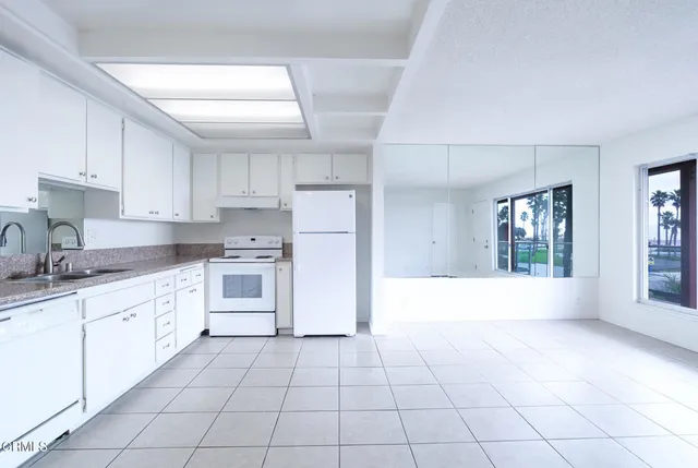 a large kitchen with cabinets and appliances