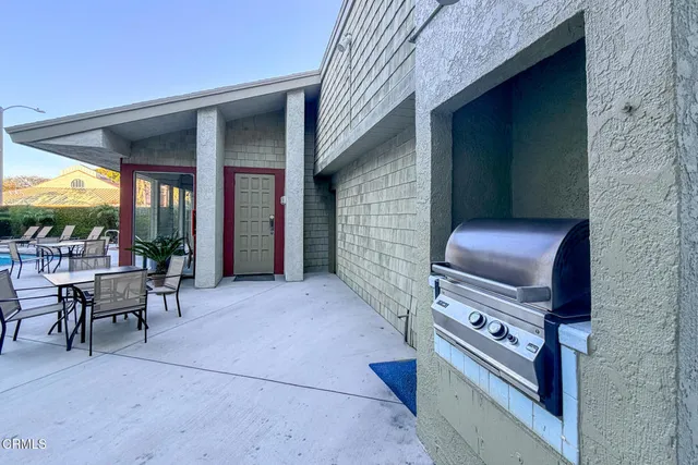 a backyard of a house with yard fire pit and outdoor seating
