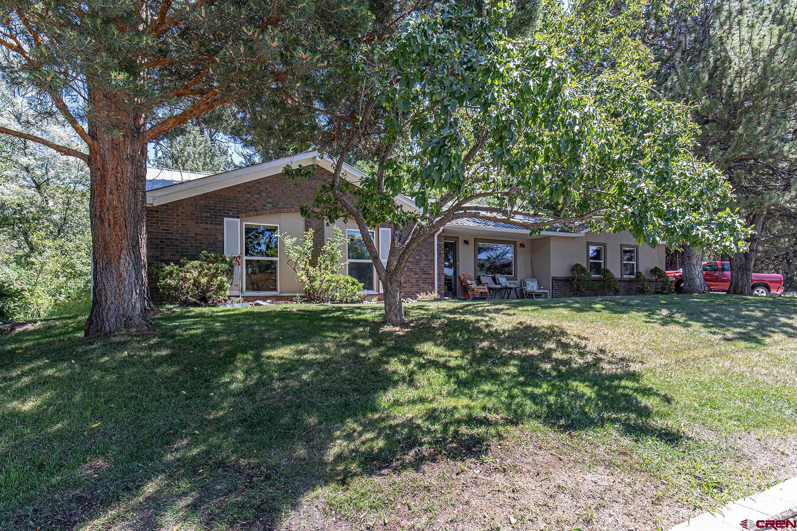 904 Florida Road Durango, CO 81301 - Photo 17 of 20 a front view of a house with a garden and trees