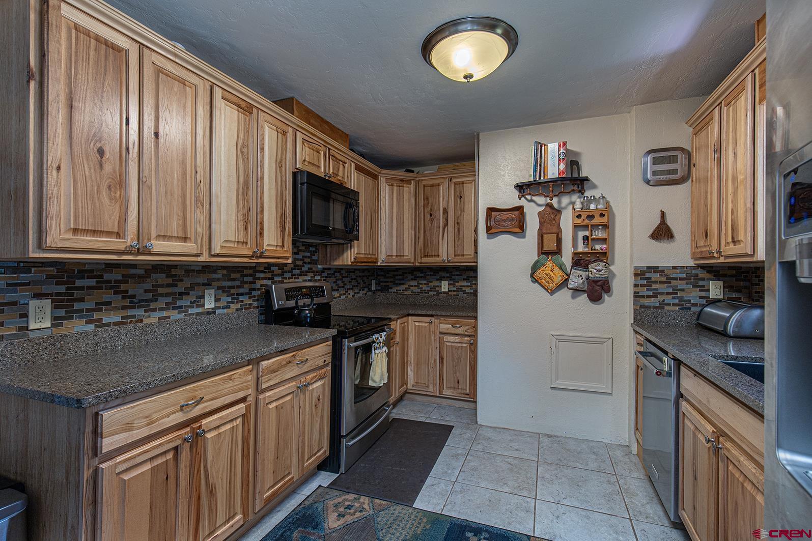 904 Florida Road Durango, CO 81301 - Photo 4 of 20 a kitchen with stainless steel appliances granite countertop a refrigerator stove and sink