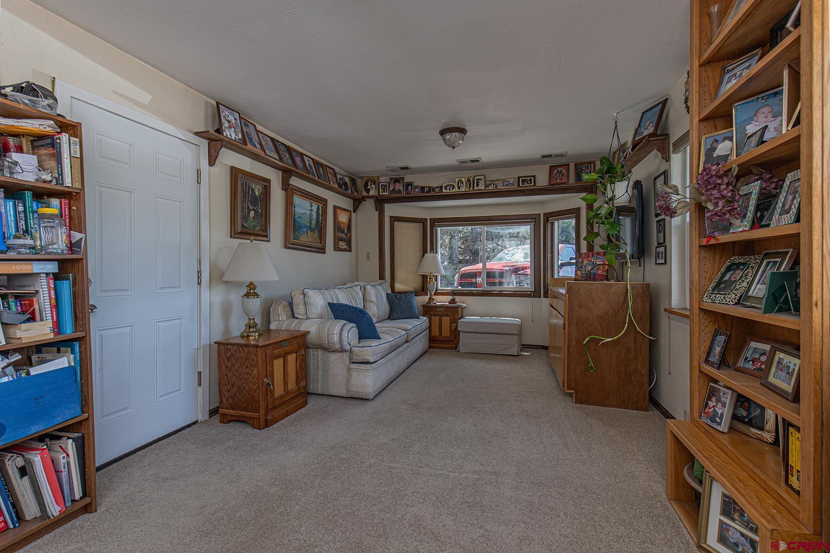 904 Florida Road Durango, CO 81301 - Photo 8 of 20 a living room with furniture and a book shelf