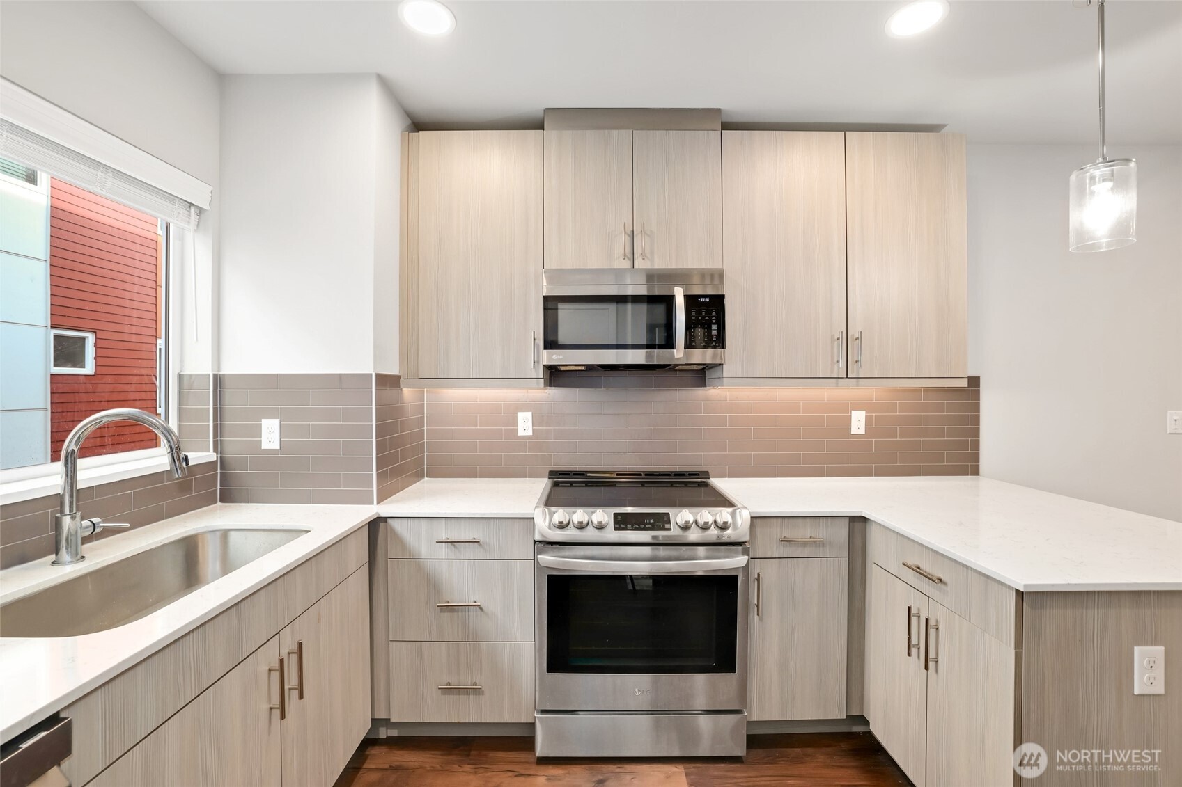 12522 15th Avenue Northeast, Unit B Seattle, WA 98125 - Photo 11 of 40 a kitchen with stainless steel appliances granite countertop a sink stove and microwave