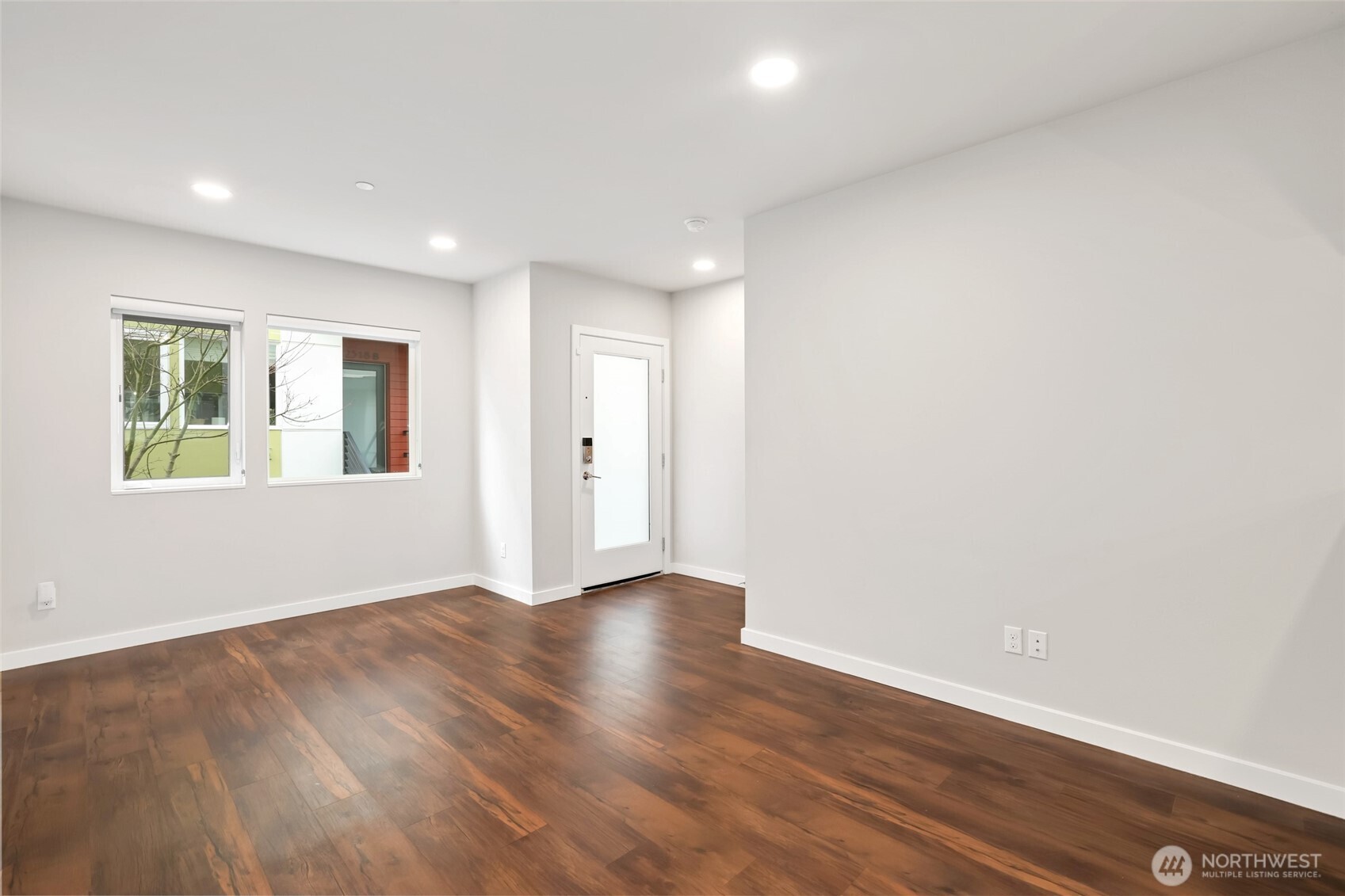 12522 15th Avenue Northeast, Unit B Seattle, WA 98125 - Photo 4 of 40 a view of an empty room with wooden floor and a window