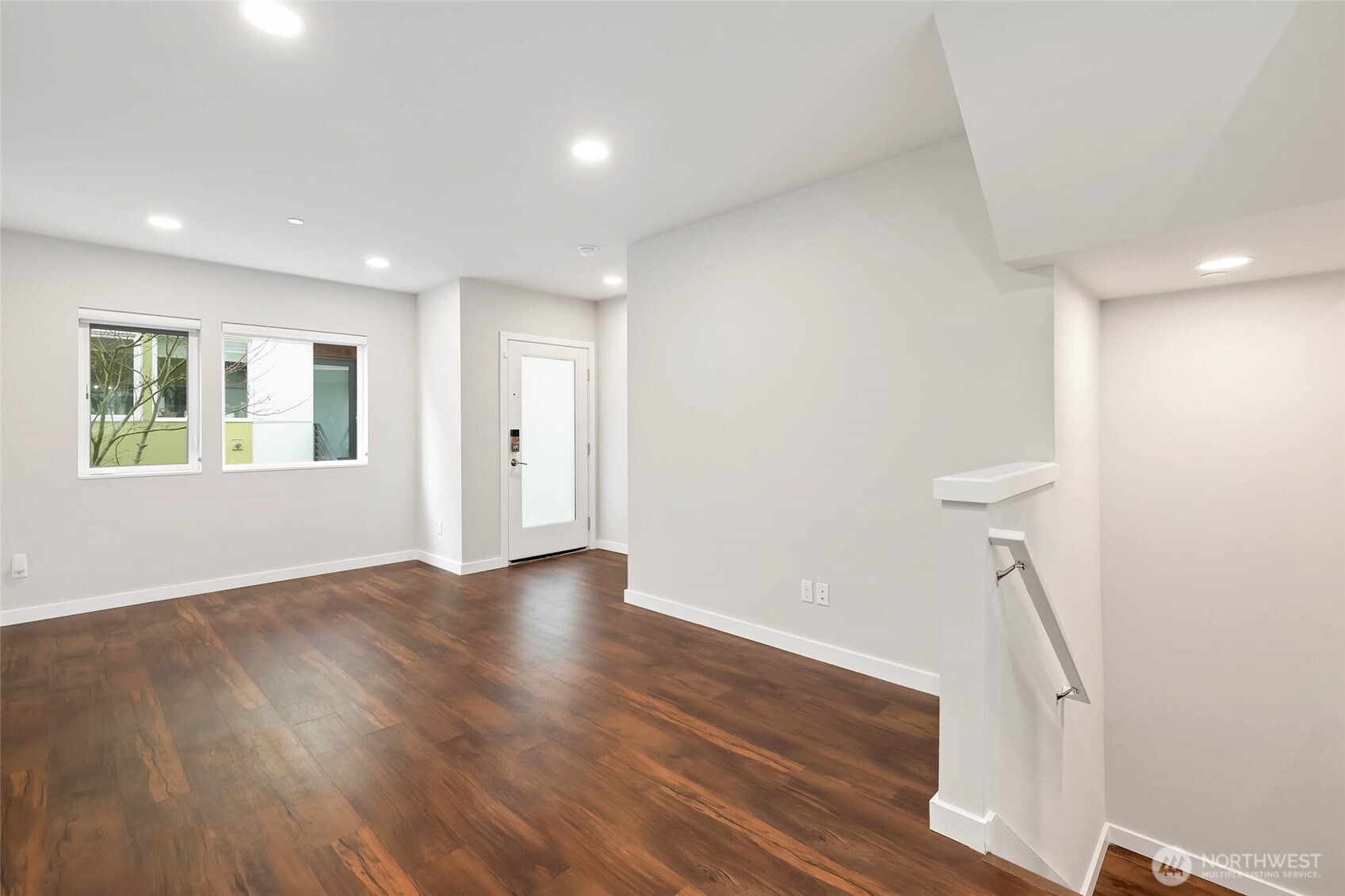 12522 15th Avenue Northeast, Unit B Seattle, WA 98125 - Photo 5 of 40 a view of an empty room with wooden floor and a window