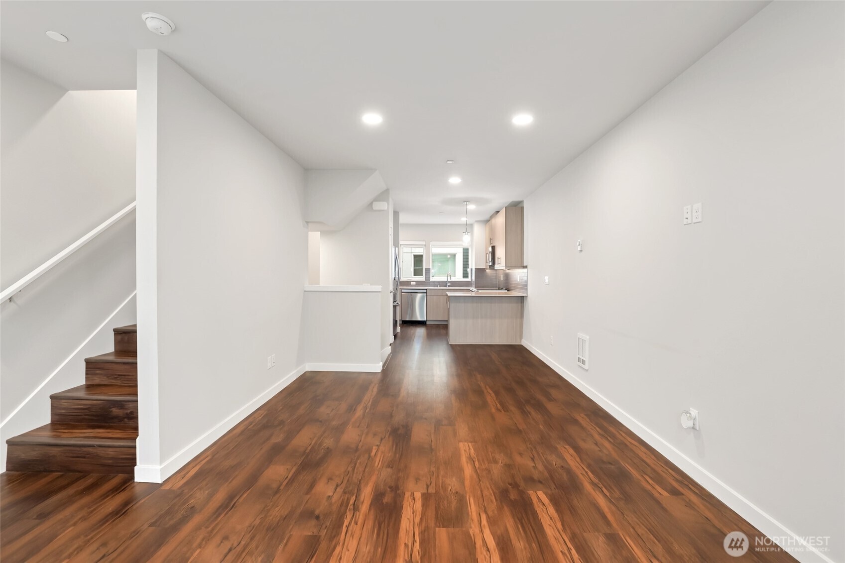 12522 15th Avenue Northeast, Unit B Seattle, WA 98125 - Photo 8 of 40 a view of a kitchen with wooden floor and electronic appliances