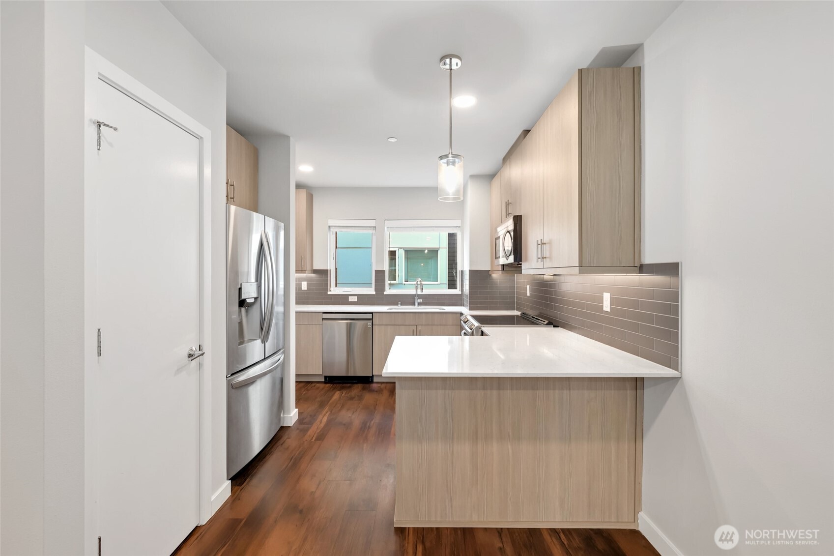 12522 15th Avenue Northeast, Unit B Seattle, WA 98125 - Photo 9 of 40 a large white kitchen with refrigerator a sink and a stove