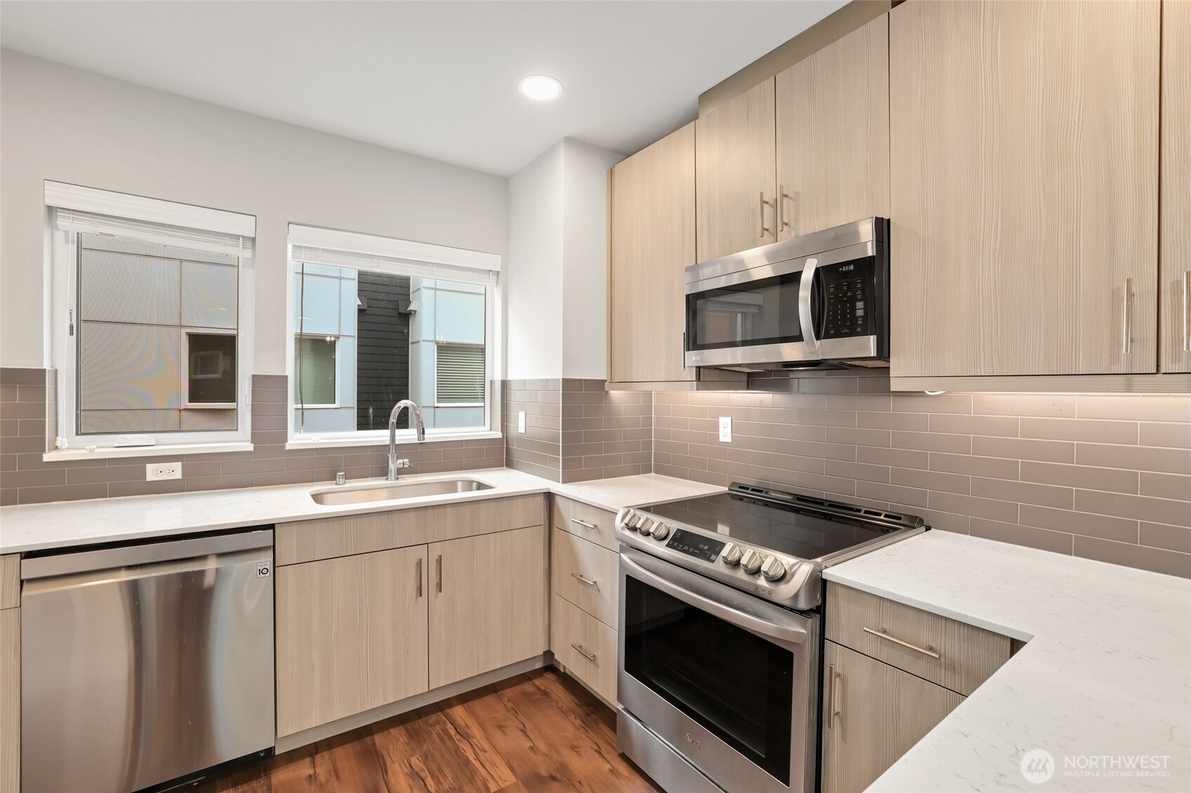 12522 15th Avenue Northeast, Unit B Seattle, WA 98125 - Photo 10 of 40 a kitchen with stainless steel appliances a sink stove and microwave