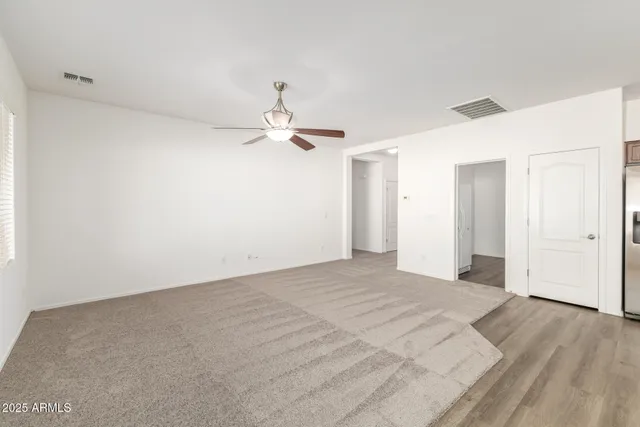 a view of an empty room with windows