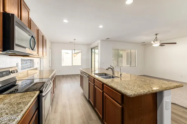 a kitchen with a sink stove and microwave