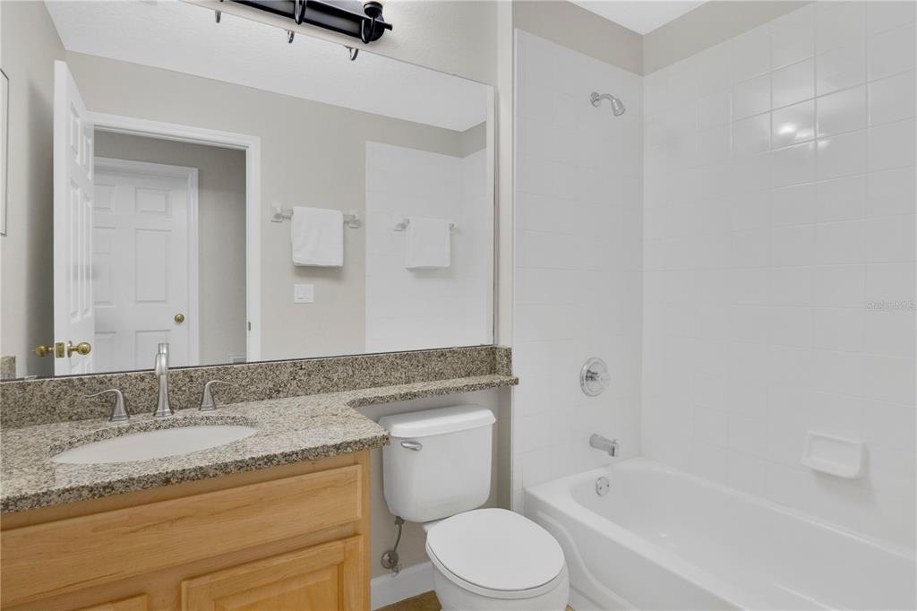 357 Kirkhill Street Ocoee, FL 34761 - Photo 20 of 36 a bathroom with a granite countertop sink a mirror and a bathtub