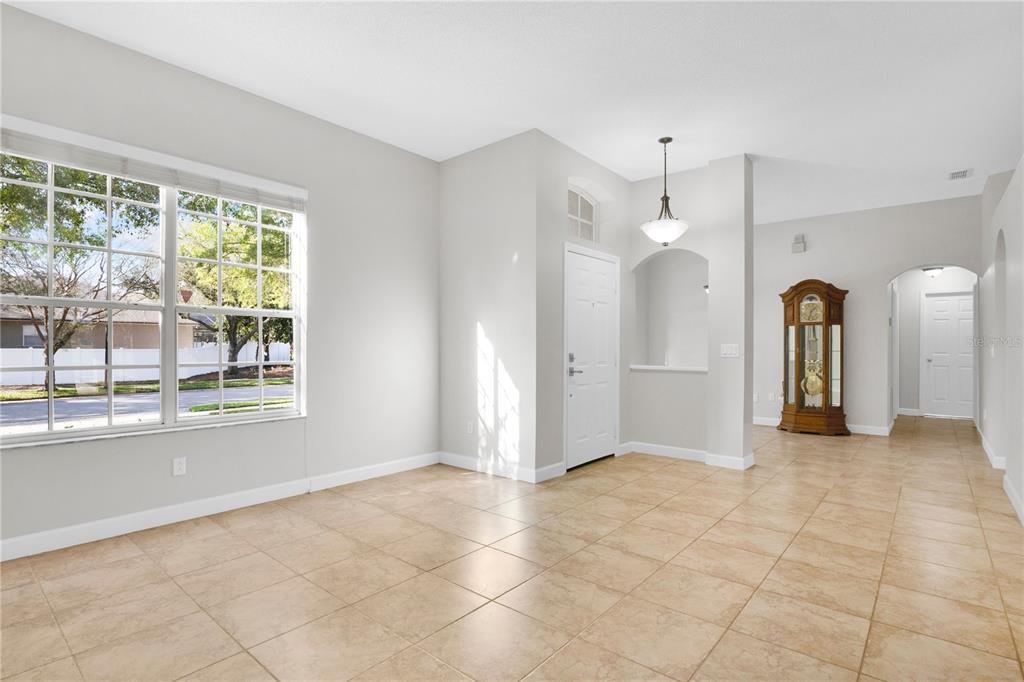 357 Kirkhill Street Ocoee, FL 34761 - Photo 3 of 36 a view of a big room with windows and chandelier
