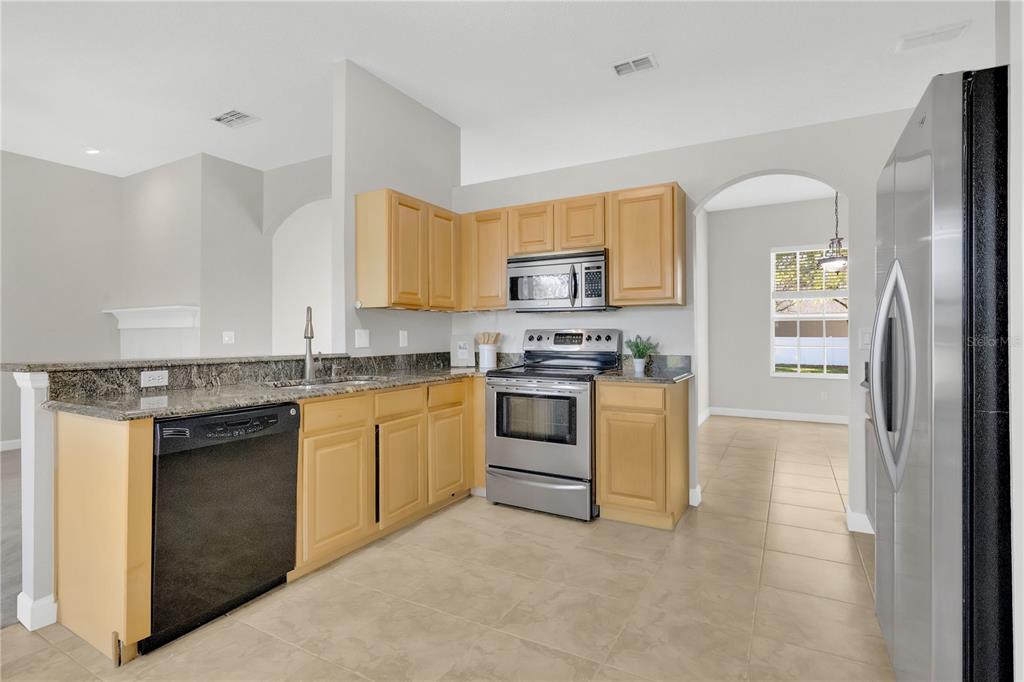 357 Kirkhill Street Ocoee, FL 34761 - Photo 5 of 36 a kitchen with a refrigerator stove and sink