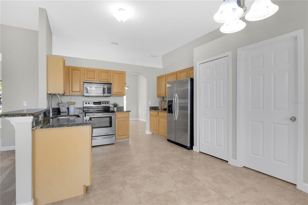 357 Kirkhill Street Ocoee, FL 34761 - Photo 6 of 36 a kitchen with sink refrigerator and microwave