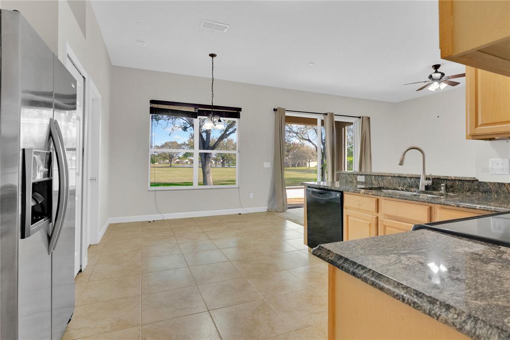 357 Kirkhill Street Ocoee, FL 34761 - Photo 8 of 36 a kitchen with stainless steel appliances granite countertop a sink stove and refrigerator