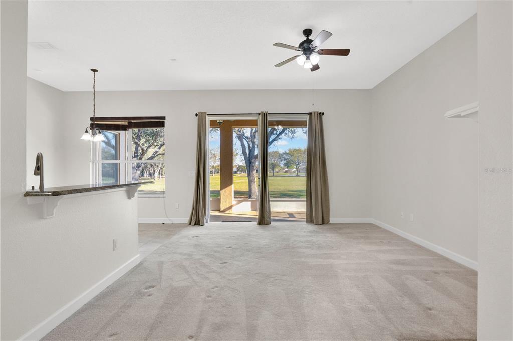 357 Kirkhill Street Ocoee, FL 34761 - Photo 9 of 36 a view of a livingroom with a ceiling fan window and a kitchen