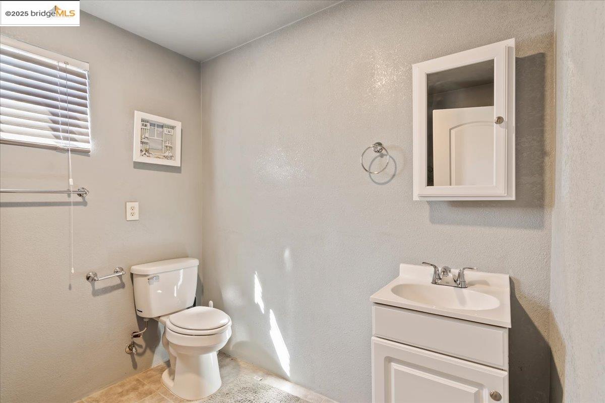 4080 Windsweep Road Bethel Island, CA 94511 - Photo 3 of 18 a bathroom with a toilet sink vanity and mirror