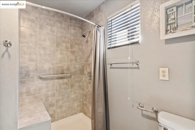 a bathroom with a shower and a toilet
