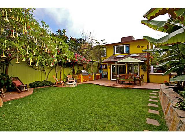 576 Hermes Avenue Encinitas, CA 92024 - Photo 7 of 19 a view of a big yard with table and chairs under an umbrella