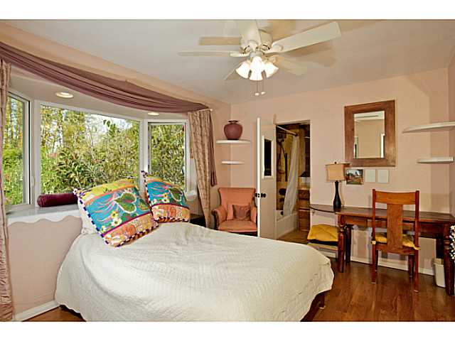 576 Hermes Avenue Encinitas, CA 92024 - Photo 8 of 19 a bedroom with a bed and a chandelier