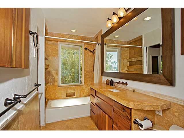 576 Hermes Avenue Encinitas, CA 92024 - Photo 9 of 19 a bathroom with a tub sink and mirror
