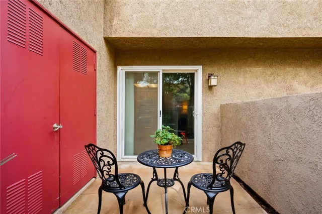 a view of a chairs and table in a patio