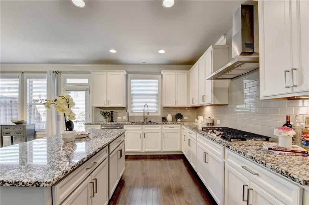4158 Butler Drive Atlanta, GA 30341 - Photo 27 of 65 a kitchen with stainless steel appliances granite countertop sink stove and cabinets