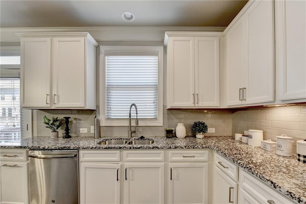 4158 Butler Drive Atlanta, GA 30341 - Photo 29 of 65 a kitchen with granite countertop white cabinets and white appliances