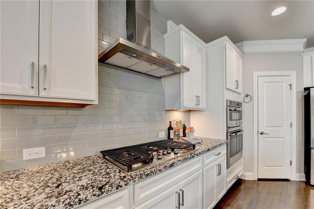 4158 Butler Drive Atlanta, GA 30341 - Photo 31 of 65 a kitchen with white cabinets and a stove