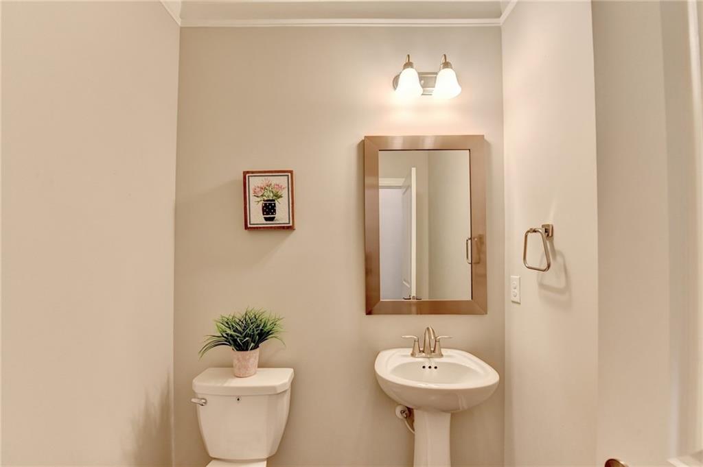 4158 Butler Drive Atlanta, GA 30341 - Photo 34 of 65 a bathroom with a toilet sink and mirror