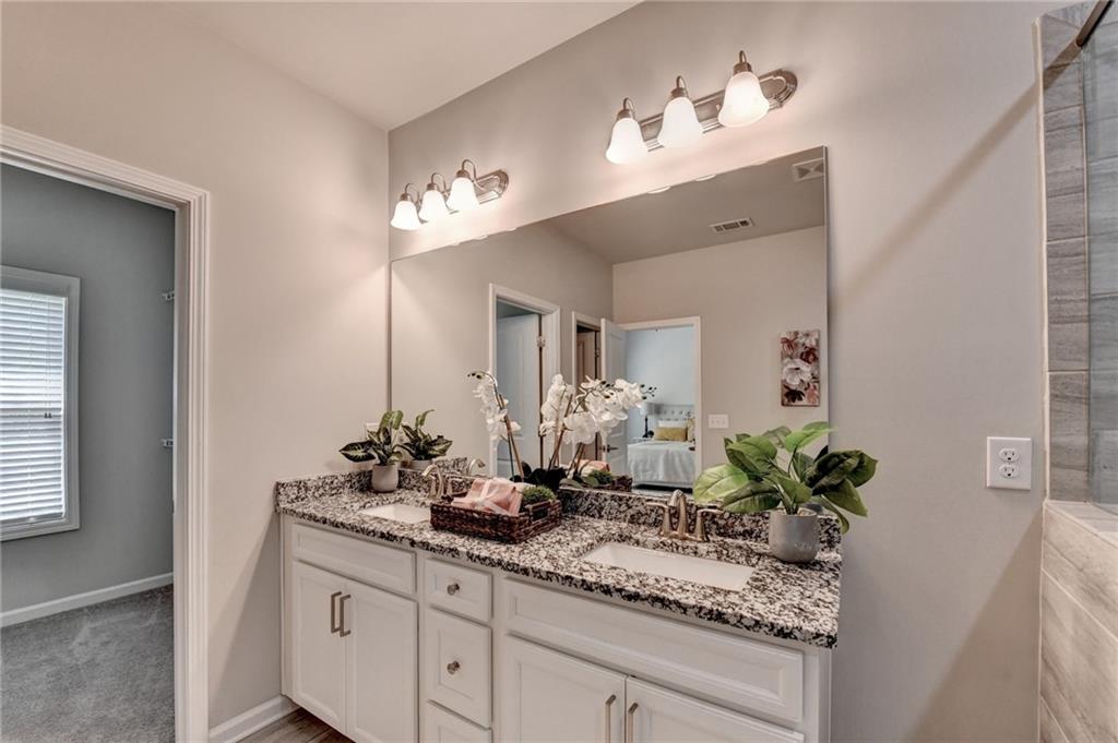 4158 Butler Drive Atlanta, GA 30341 - Photo 44 of 65 a bathroom with a granite countertop sink and a mirror