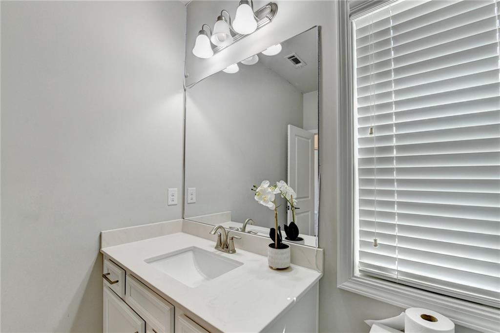 4158 Butler Drive Atlanta, GA 30341 - Photo 51 of 65 a bathroom with a sink a vanity and a mirror