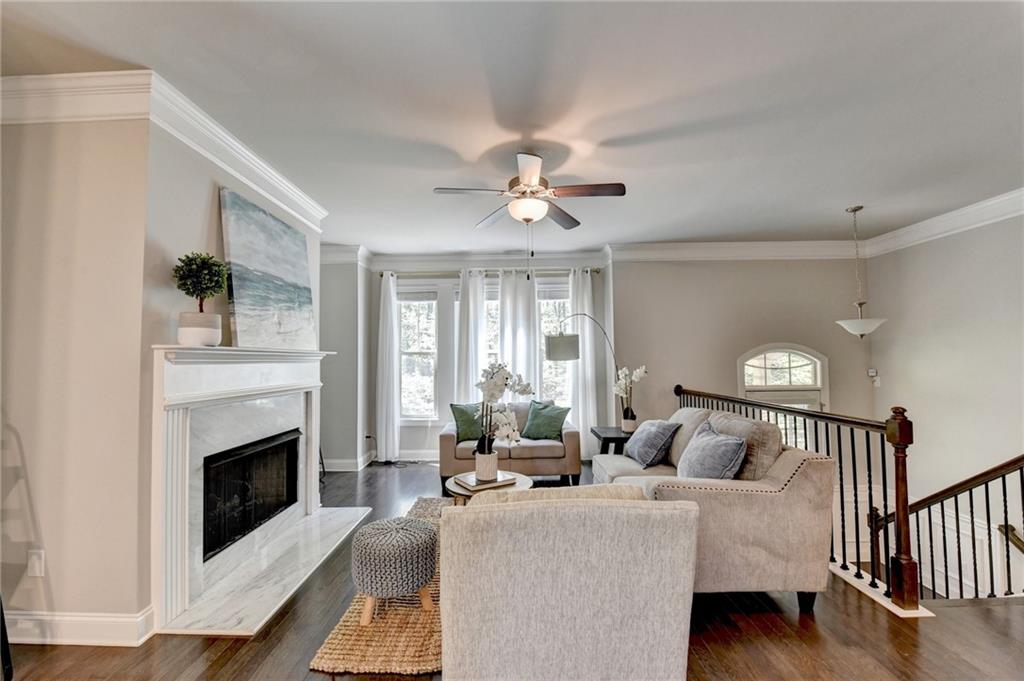 4158 Butler Drive Atlanta, GA 30341 - Photo 9 of 65 a living room with furniture a fireplace and a ceiling fan
