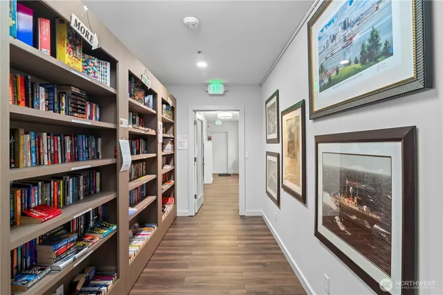 a hallway with a book shelf and a book shelf