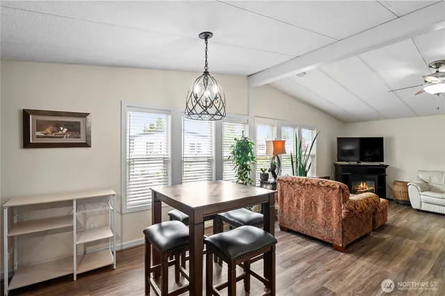 a living room with furniture a chandelier and a flat screen tv
