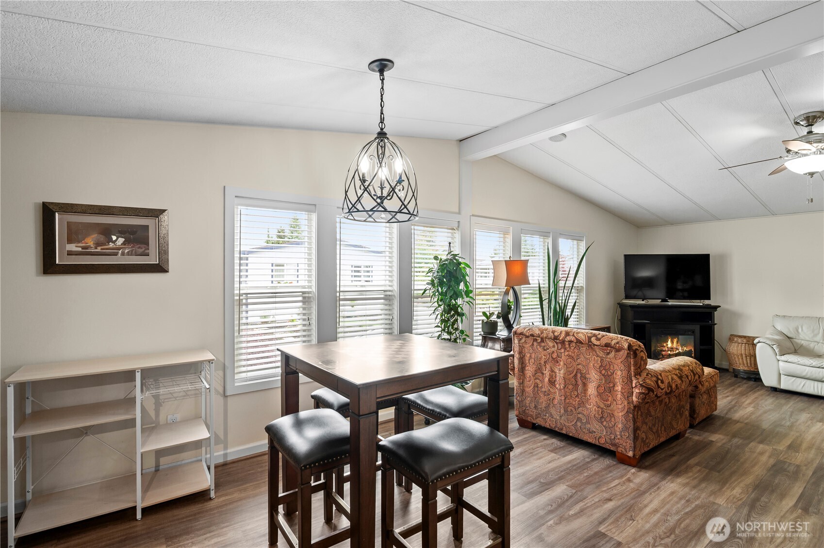 1427 100th Street Southwest, Unit 145 Everett, WA 98204 - Photo 19 of 36 a living room with furniture a chandelier and a flat screen tv