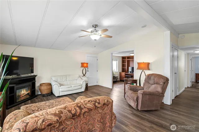 a living room with furniture a flat screen tv and a fireplace