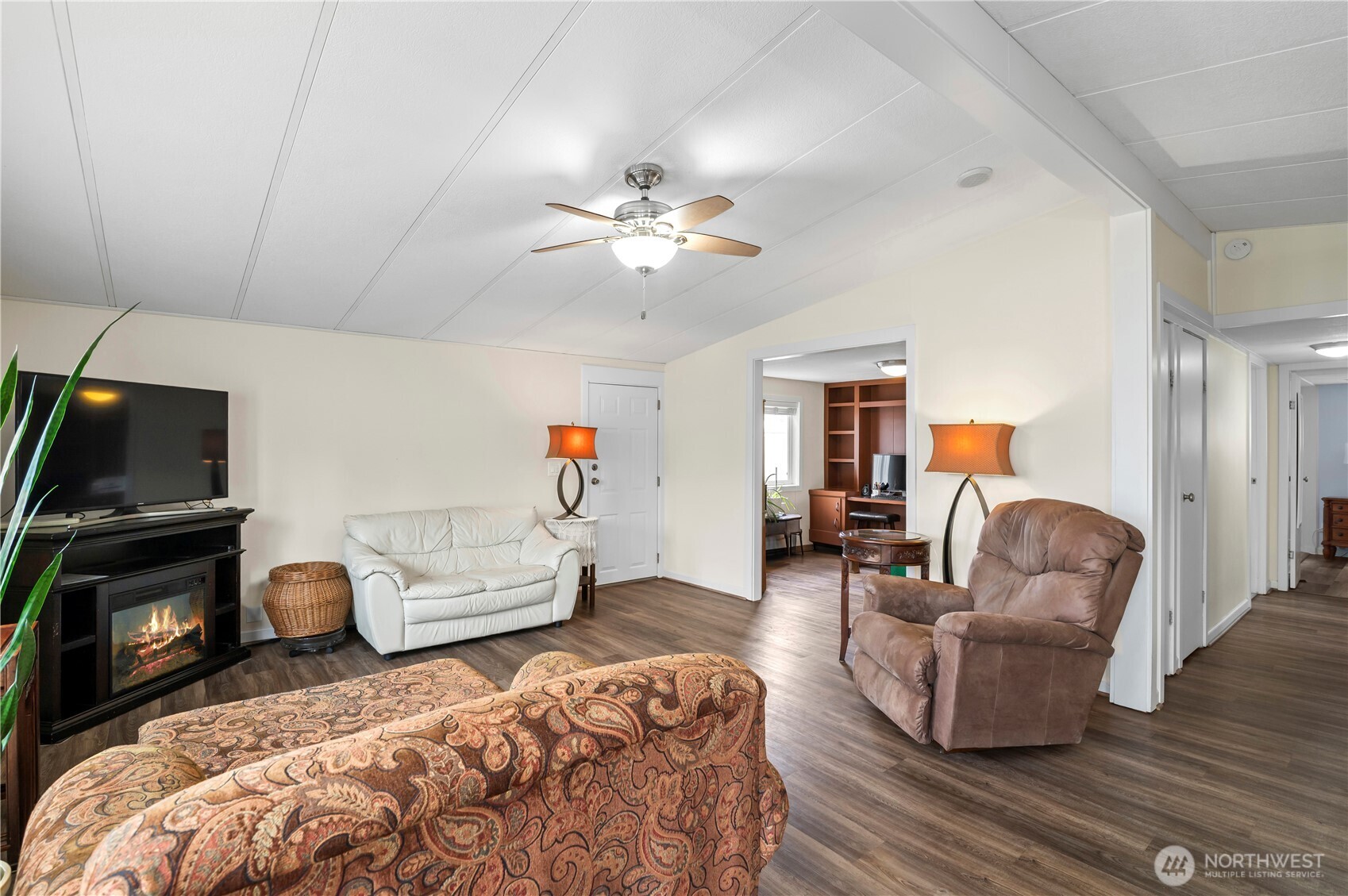 1427 100th Street Southwest, Unit 145 Everett, WA 98204 - Photo 20 of 36 a living room with furniture a flat screen tv and a fireplace